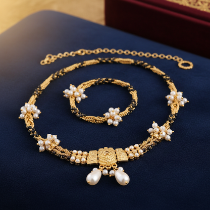 Gold-plated mangalsutra with pearl moti beads on velvet jewelry display